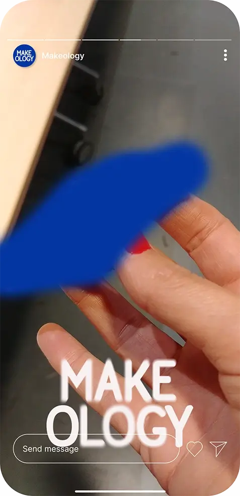 Close-up of a hand with red nail polish on the middle finger over a gray background.